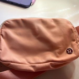 Melon color ish with white lululemon belt bag